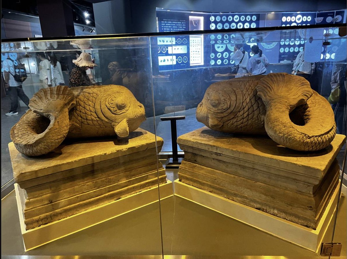 Stone fish fountains at the park museum